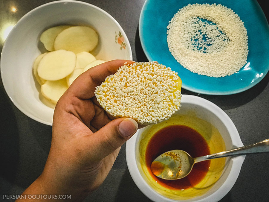 Preparing potato tahdig for baghali polo